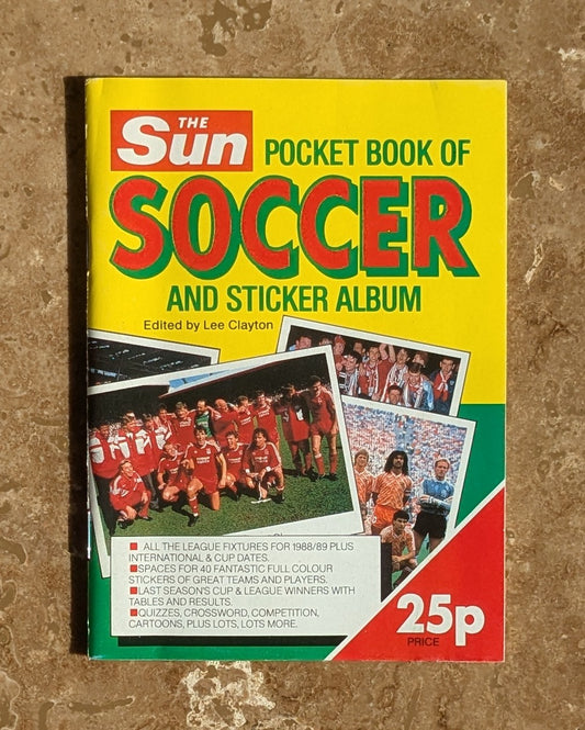 Vintage 'The Sun' pocket book of soccer and sticker album on a textured surface