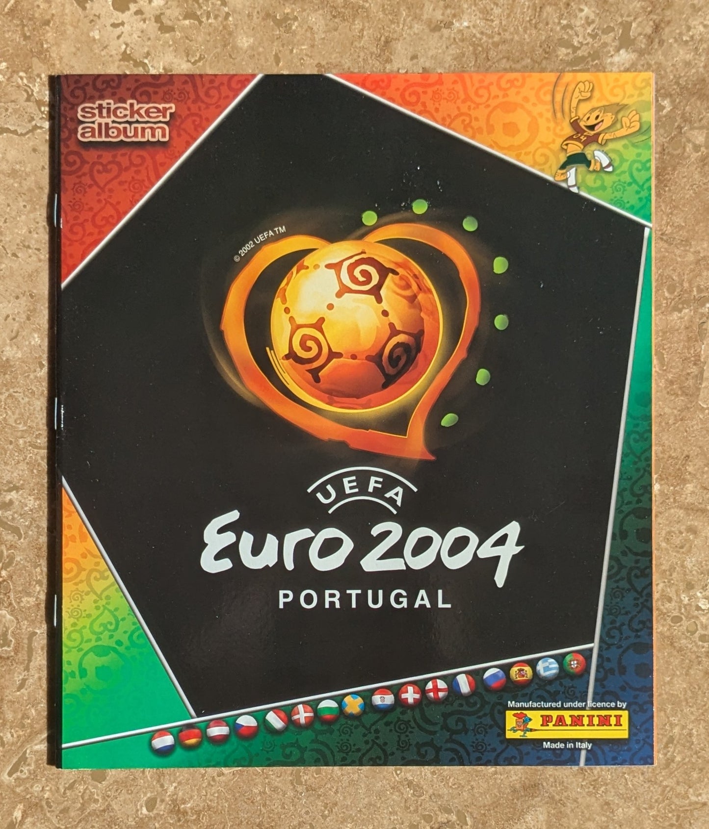 Sticker album for UEFA Euro 2004 Portugal with colorful design and Panini logo.